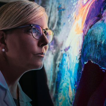 Scientist looking at an image of the human brain with nerve fibers made visible